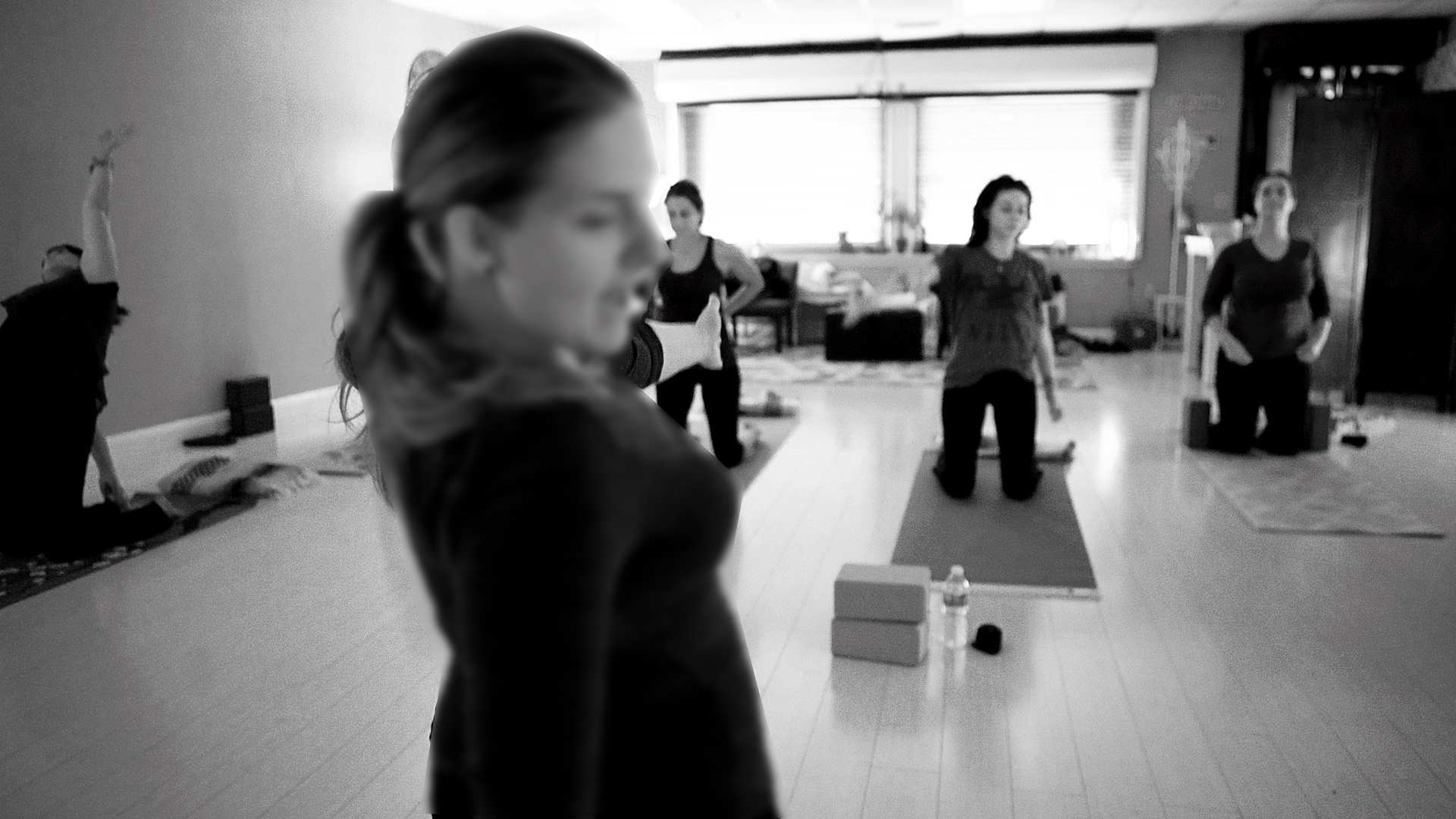 Black and white photo of yoga class in session at the studio